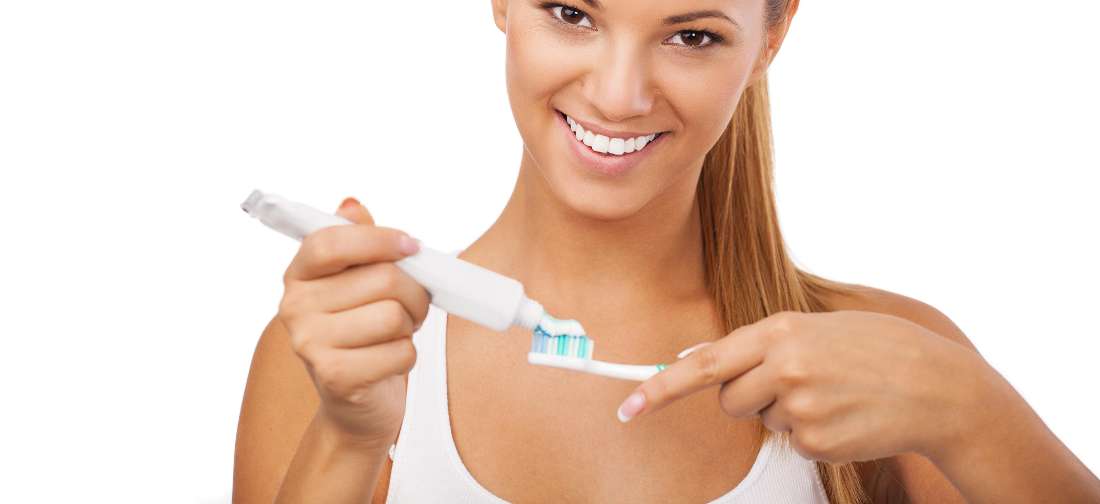 a woman holding a toothbrush