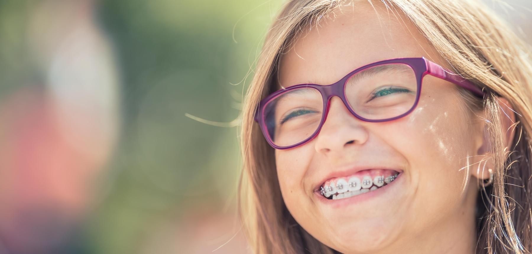 Young girl with braces smiling in Northborough, MA